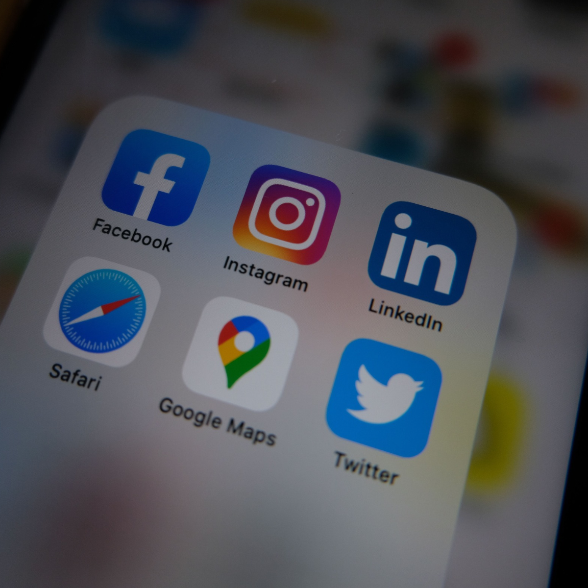 Mobile phone screen displaying app icons for social media, including Facebook, Instagram, LinkedIn, and Twitter.